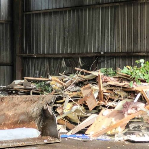 Bulldozer at trash disposal site ready to sort trash for removal to another site.